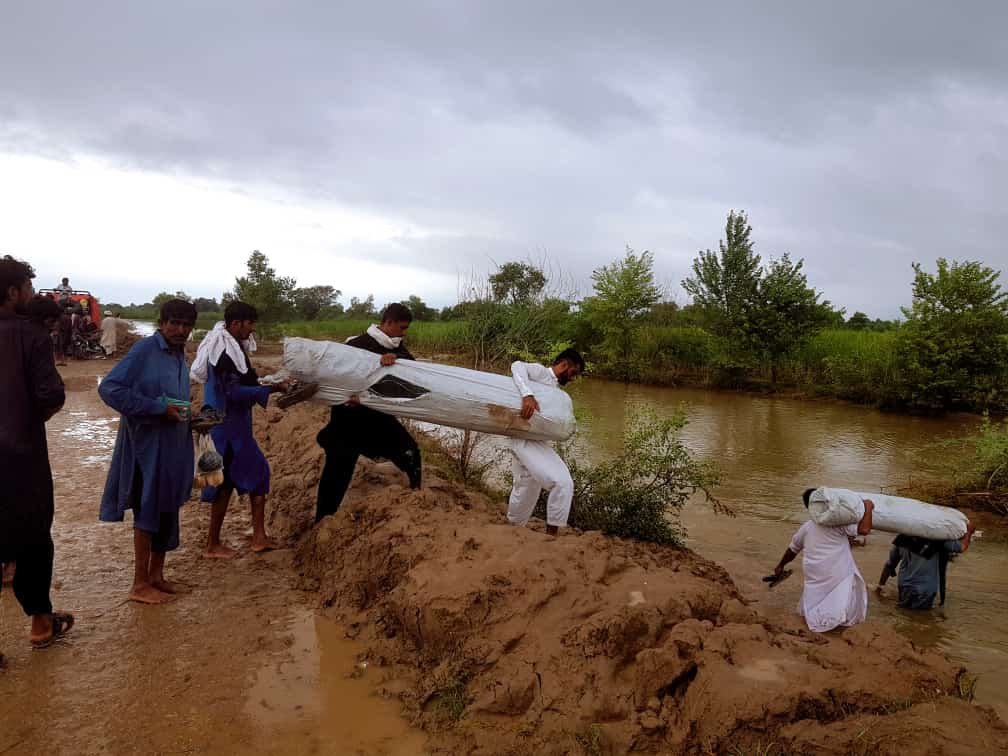 Emergency flood relief response team assessing a collapsed building