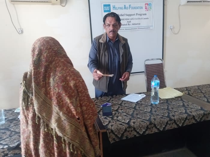 A recipient collecting their household's flood relief payment