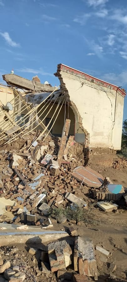Collapsed masonry in an affected neighbourhood.
