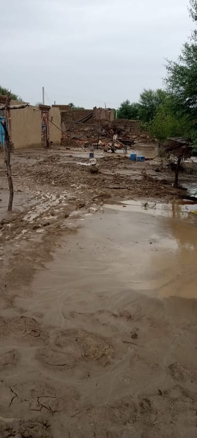 Standing water and mud left across a residential lane.
